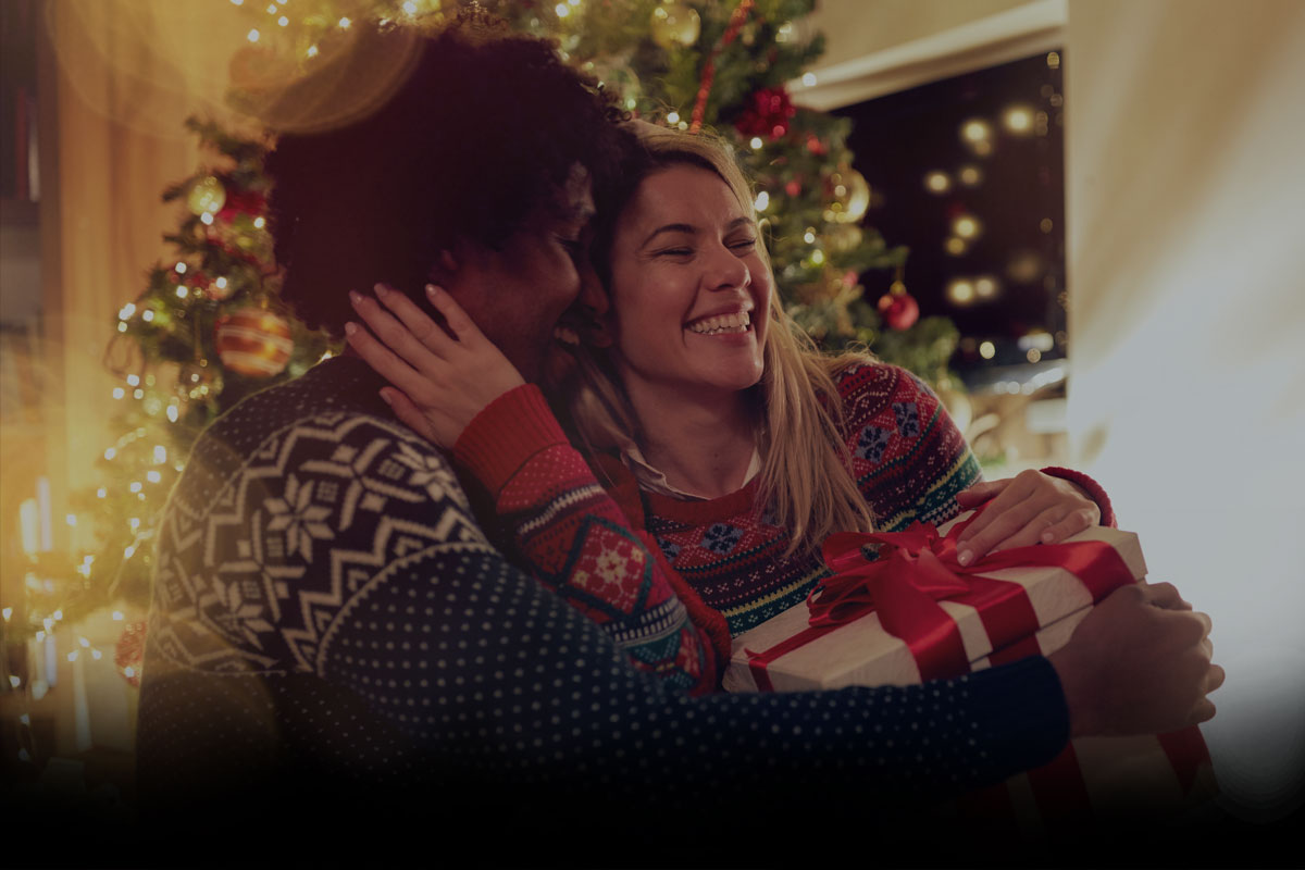 Christmas couple exchanging Christmas presents