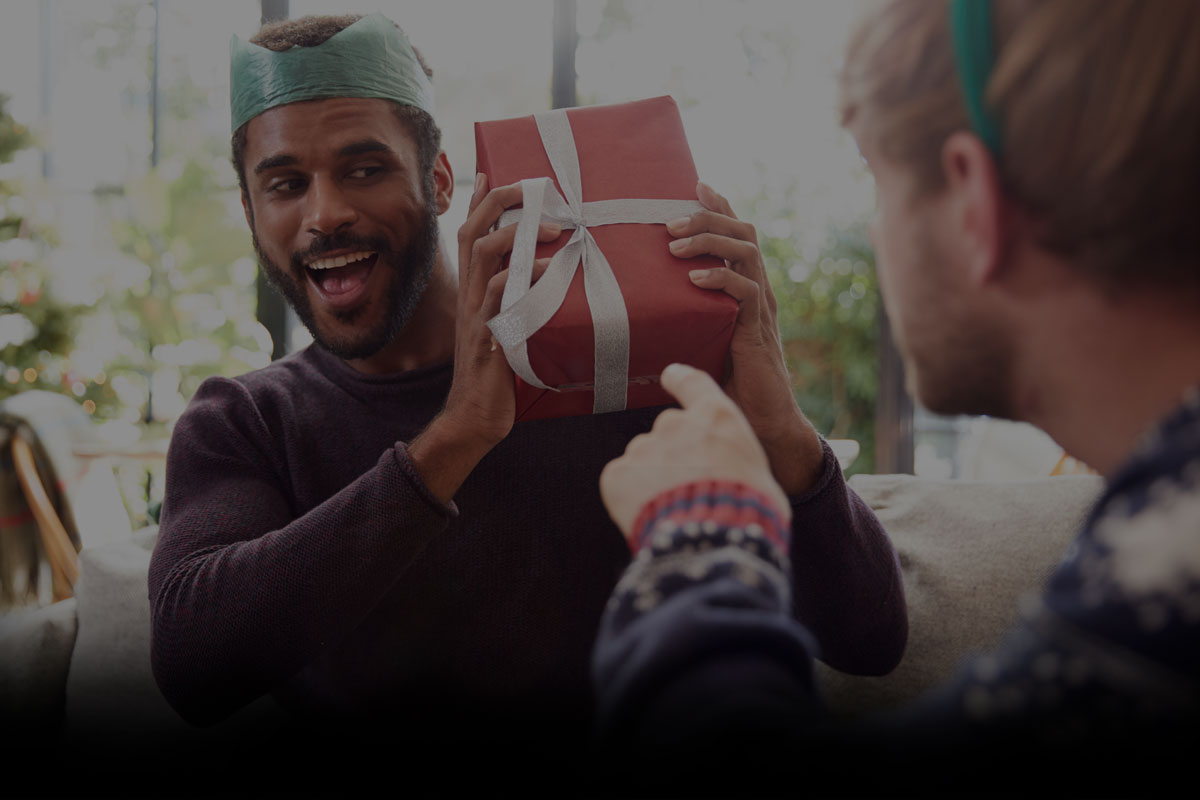 Man opening his Christmas presents